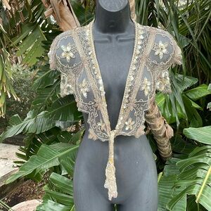 Sheer sequin and beaded caplet or collar.